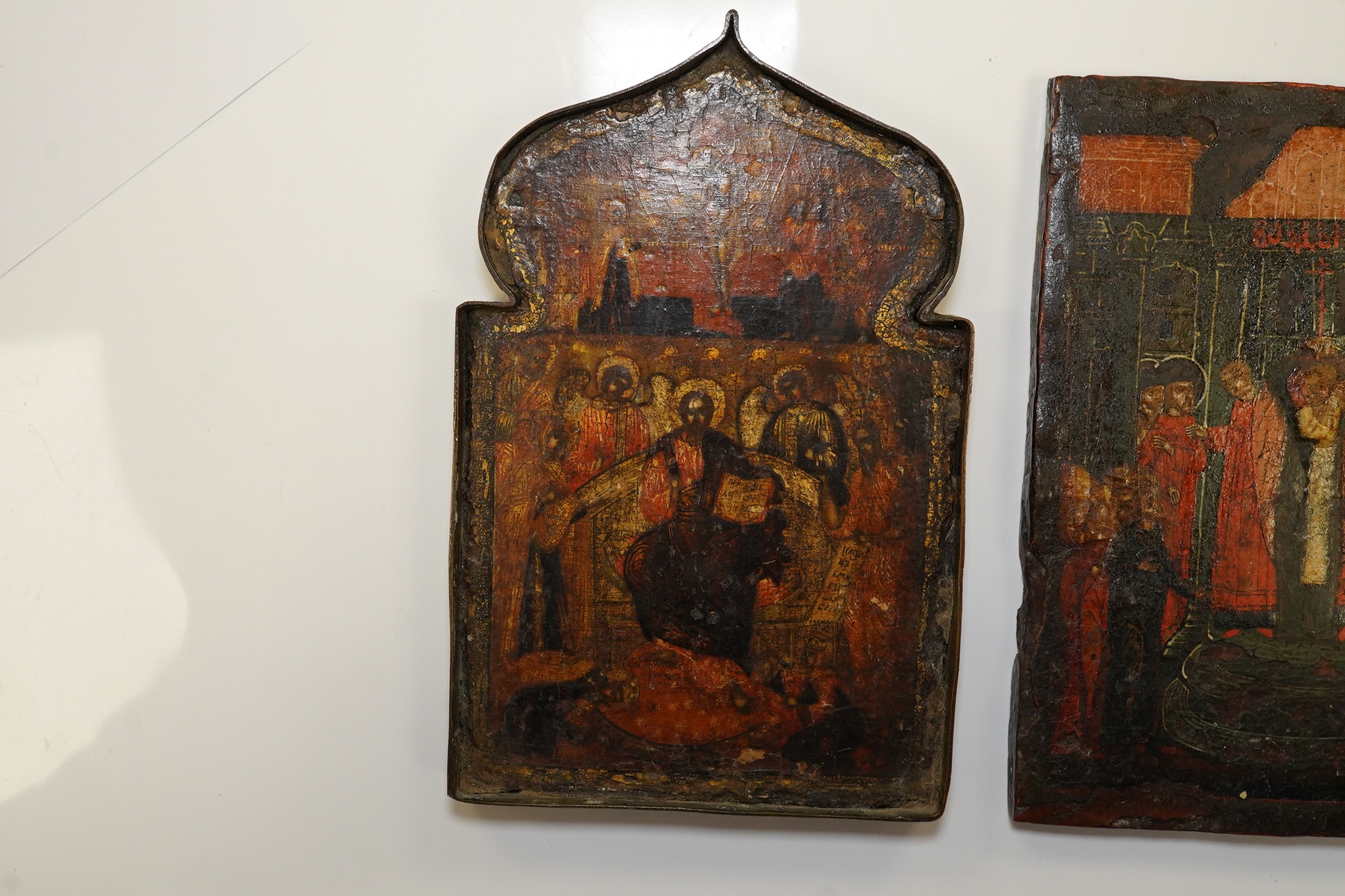 A pair of 17th century or later Russian painted wood icons, and another similar, 13.5 x 10cm. Condition - poor to fair